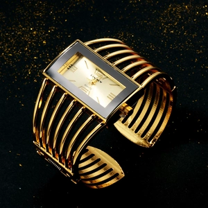Macro view of a luxury gold rectangular quartz bangle watch with black Roman numeral dial
