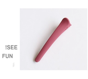 Close-up of matte dusty pink bobby pin with a minimalist textured finish for hair styling