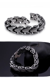 Macro view of vintage dragon scale pattern on a gray 316L stainless steel men's bracelet
