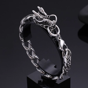 Mens vintage stainless steel dragon head bracelet with antique silver finish on display