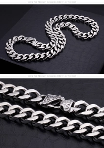 Detail of masculine stainless steel Cuban link chain with engraved triangle clasp