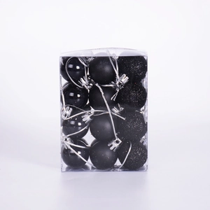 Detail of 24 black Christmas balls in glossy, matte, and glitter finishes in a clear box