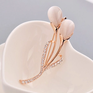 Elegant rose gold tulip brooch with opal petals and sparkling zircons in a heart ceramic dish