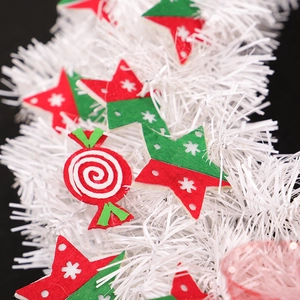 White Christmas tinsel garland with red and green felt stars and candy cane decorations
