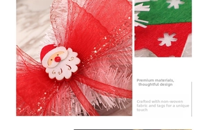 Macro detail of Christmas bow with Santa felt patch and red green snowflake cutouts