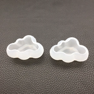 Detailed view of two semi-transparent cloud-shaped silicone molds for DIY resin casting