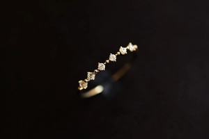 Macro detail of gold-plated silver ring featuring seven micro-set sparkling zircons