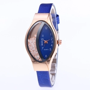 Detail view of rose gold quartz watch with blue snakeskin strap and floating rhinestones