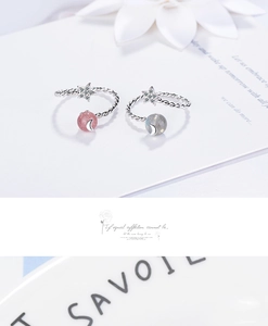 Detail of twisted rope rings with star charms and pink and blue strawberry quartz beads