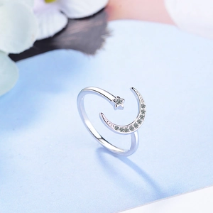 Adjustable S925 silver open ring featuring star and moon designs with sparkling crystals