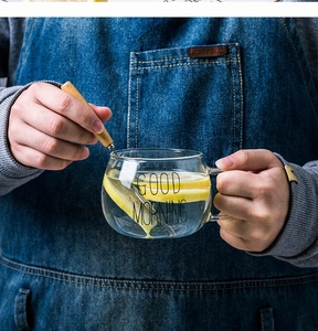 Détail de la tasse Good Morning avec eau citronnée et cuillère mélangeuse en bois
