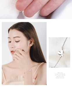 Detailed close-up and model view of an elegant silver butterfly pendant bracelet with crystals