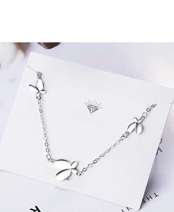 Detail of silver butterfly bracelet with sparkling crystal accents on a white display card