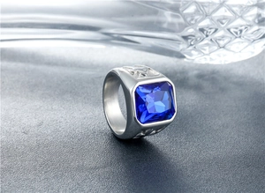 Macro shot of punk style stainless steel ring with square blue gemstone and side carvings