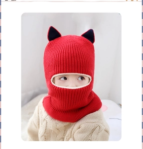 Detail of red knit kids hat with black cat ears and integrated fleece neck warmer