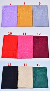 Multiple colors of floral lace headscarf fabric with tassel details in a grid layout