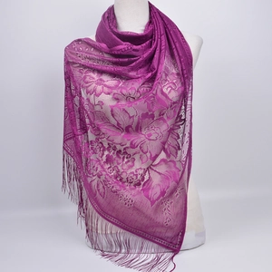 Detail view of deep purple floral lace shawl with delicate long fringe tassels