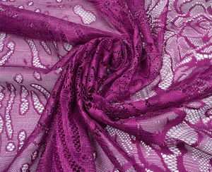 Macro close-up of purple lace fabric featuring intricate hollow floral patterns and mesh texture