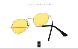 Side view of vintage oval metal sunglasses with yellow lenses and golden frame display