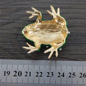 Detail view of green enamel frog brooch back with safety pin and 5.8cm size reference