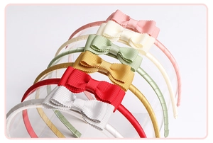 Detail of six-color ribbed fabric bow headbands arranged on a transparent display stand