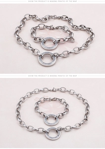 Macro shot of silver chunky chain jewelry set featuring zircon encrusted circular pendants