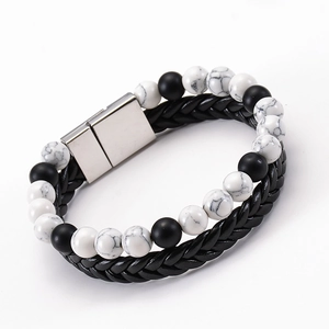 Detail of double-layer lava stone bead bracelet with woven leather and magnetic clasp