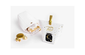 Detail of white candy box with gold Merci foil stamping and elegant silk ribbon tie