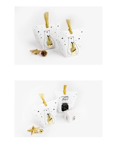 Detailed view of polar bear and starry sky print candy boxes with gold glitter ribbons