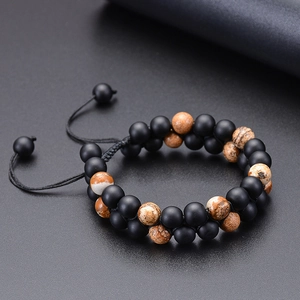 Detailed macro view of double-layer braided natural stone beads with adjustable black cord