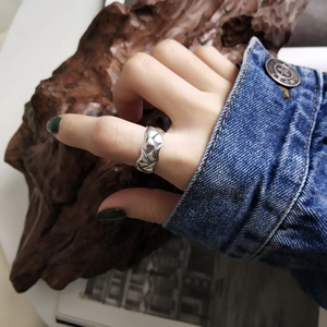 Close-up of 925 sterling silver woven ring texture shown on model finger