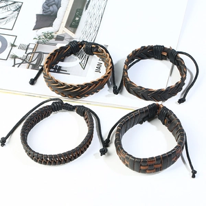 Set of four woven leather bracelets in black and dark brown with adjustable knot closures