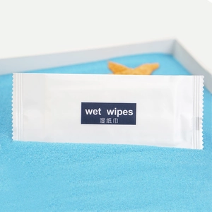 Individually wrapped wet wipes on blue sand with starfish decoration for a fresh ocean look