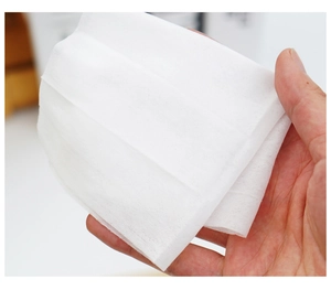 Close-up of soft white non-woven texture and fiber detail of disposable travel wipe