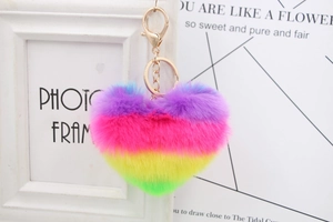 Detailed view of rainbow gradient heart plush keychain with golden metal clasp