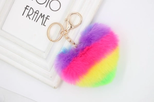 Detailed view of plush rainbow heart keychain with gold chain on a white background