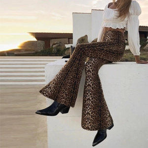 Detailed outdoor view of high waist leopard print flare pants during sunset light