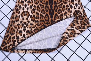 Close-up detail of high waist leopard print pants showing seam stitching and knit texture