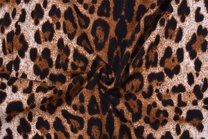 Macro shot of leopard print fabric showing smooth texture and high-quality brown patterns