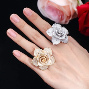Macro shot of rose flower rings with micro-paved zircons in gold and silver plating