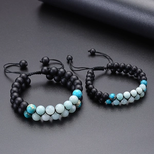 Detail of hand-woven adjustable double-layer bracelets with matte black and Amazonite beads