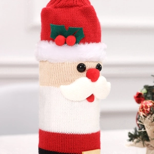 Macro shot of knitted Santa wine bottle cover with detailed texture for Christmas decor