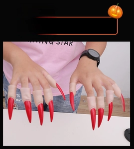 Detailed view of red long claw finger nails for Halloween witch or demon costumes