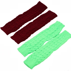 Knitted leg warmers in dark red and light green with chunky cable knit pattern textures