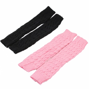 Detailed view of cable knit leg warmers in black and pink showing soft texture
