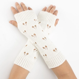 Close-up of white knitted arm warmers featuring heart-shaped cutout detail and fingerless design