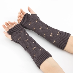 Close-up of dark coffee knitted arm warmer with elegant hollow pattern and fingerless design