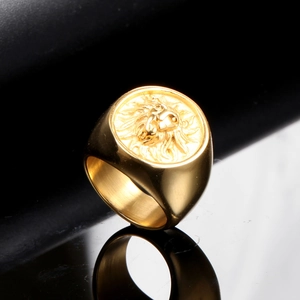 Macro shot of gold lion head relief on a stainless steel punk ring for men