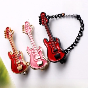 Macro detail of mini guitar brooches in red and pink colors with gold-tone metal finish
