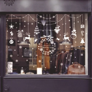 White Christmas window decals with snowflakes reindeer and Merry Christmas wreath
